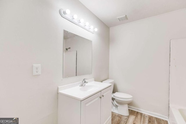 full bathroom featuring tub / shower combination, wood-type flooring, vanity, and toilet