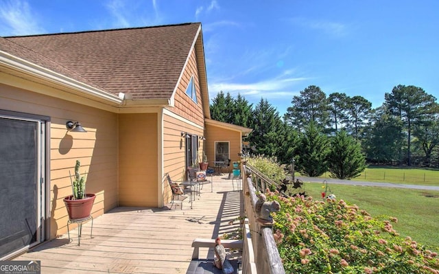 wooden deck with a lawn