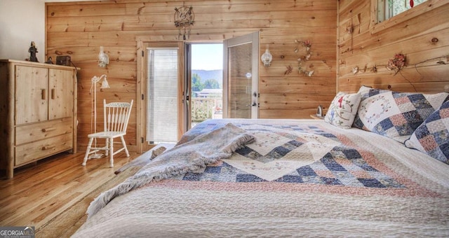 2051 Little Texas Valley Rd, Rome, GA 30165 - bedroom with wooden walls, access to exterior, and wood finished floors