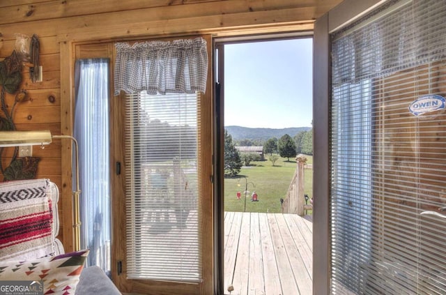 doorway with a mountain view and wooden walls