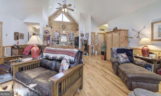 bedroom with light hardwood / wood-style flooring, wooden walls, ceiling fan, and high vaulted ceiling