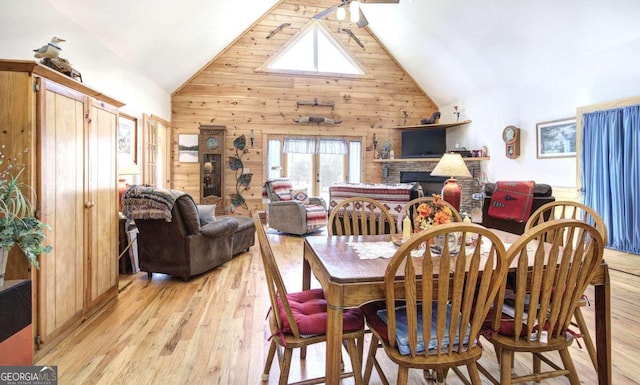 2051 Little Texas Valley Rd, Rome, GA 30165 - dining space with wood walls, plenty of natural light, high vaulted ceiling, and light wood-style flooring