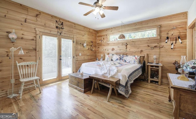 2051 Little Texas Valley Rd, Rome, GA 30165 - bedroom featuring light wood-style floors, a ceiling fan, access to exterior, wood walls, and french doors