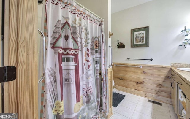 bathroom featuring vanity, tile patterned flooring, and toilet