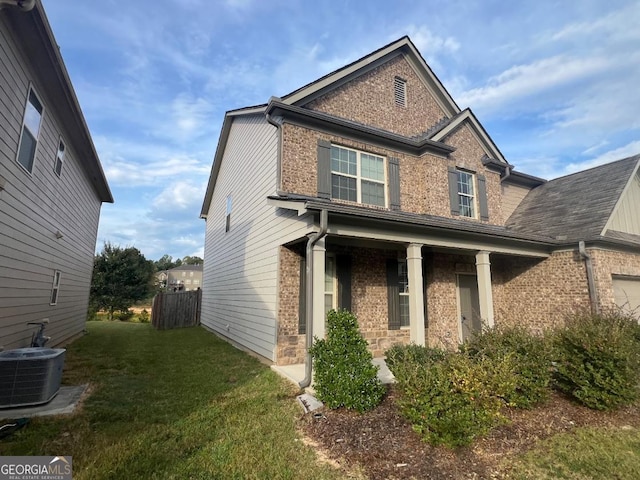 craftsman house featuring central AC unit and a front lawn