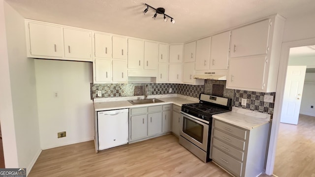 kitchen with sink, stainless steel gas range, white cabinets, and dishwasher