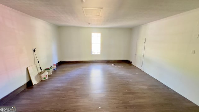 empty room featuring dark wood-type flooring