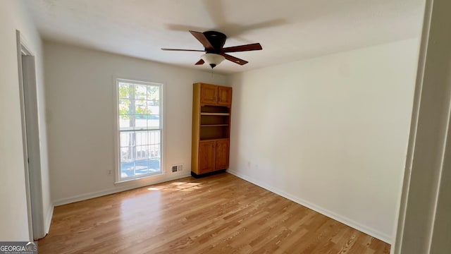 unfurnished room featuring ceiling fan and light hardwood / wood-style flooring