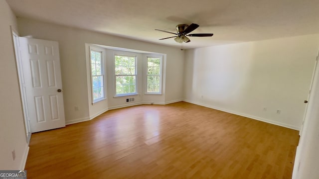 unfurnished room with light hardwood / wood-style flooring and ceiling fan