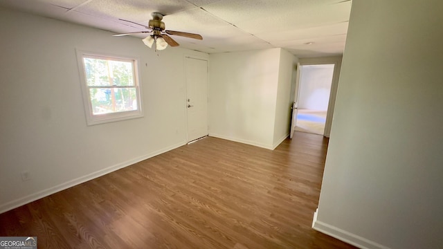 empty room featuring ceiling fan and wood-type flooring