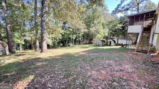 view of yard featuring a storage shed and a sunroom