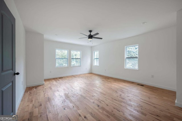 empty room featuring ceiling fan and light hardwood / wood-style floors