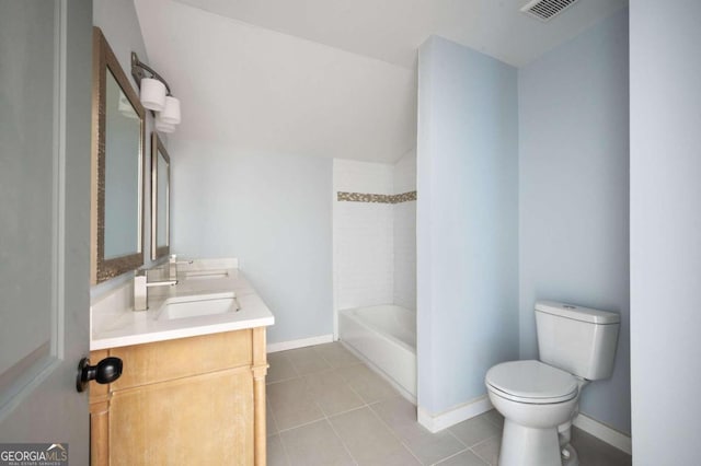 full bathroom with tile patterned floors, vanity, tiled shower / bath combo, and toilet