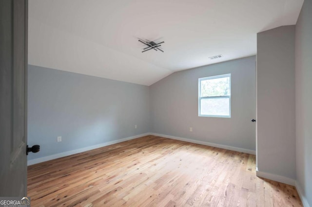 bonus room featuring light hardwood / wood-style flooring and vaulted ceiling