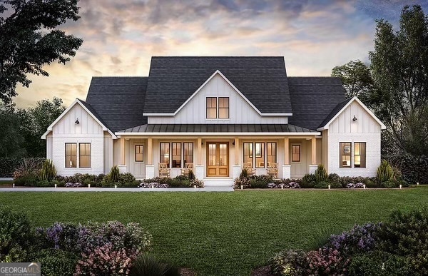 modern farmhouse with a lawn and covered porch