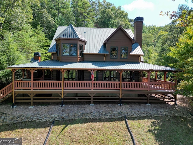 back of house with a wooden deck