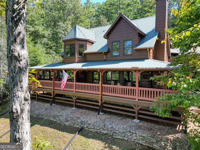 rear view of property with a wooden deck