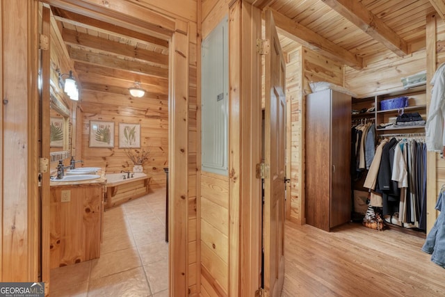 bathroom featuring vanity, wood ceiling, beam ceiling, a bath, and tile patterned floors