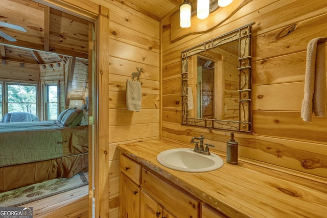 bathroom with wood walls and vanity