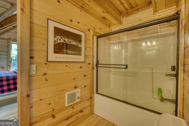 bathroom featuring enclosed tub / shower combo, wood-type flooring, wood ceiling, and wooden walls