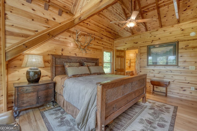 bedroom featuring ceiling fan, wooden walls, light wood-type flooring, and wooden ceiling