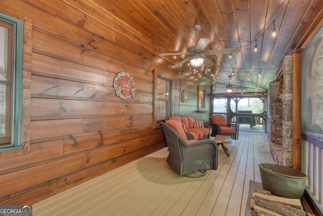 interior space featuring wood walls, wooden ceiling, wood-type flooring, lofted ceiling, and ceiling fan