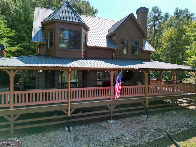 back of property featuring a wooden deck