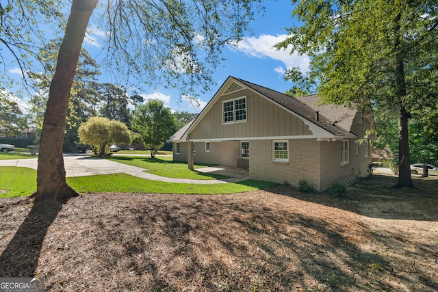 view of side of home with a yard