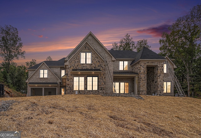 view of front facade featuring french doors, a lawn, and a garage