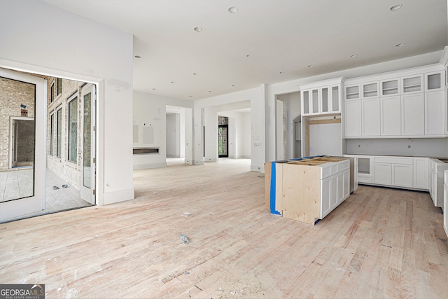 kitchen featuring light hardwood / wood-style floors, white cabinets, and a center island