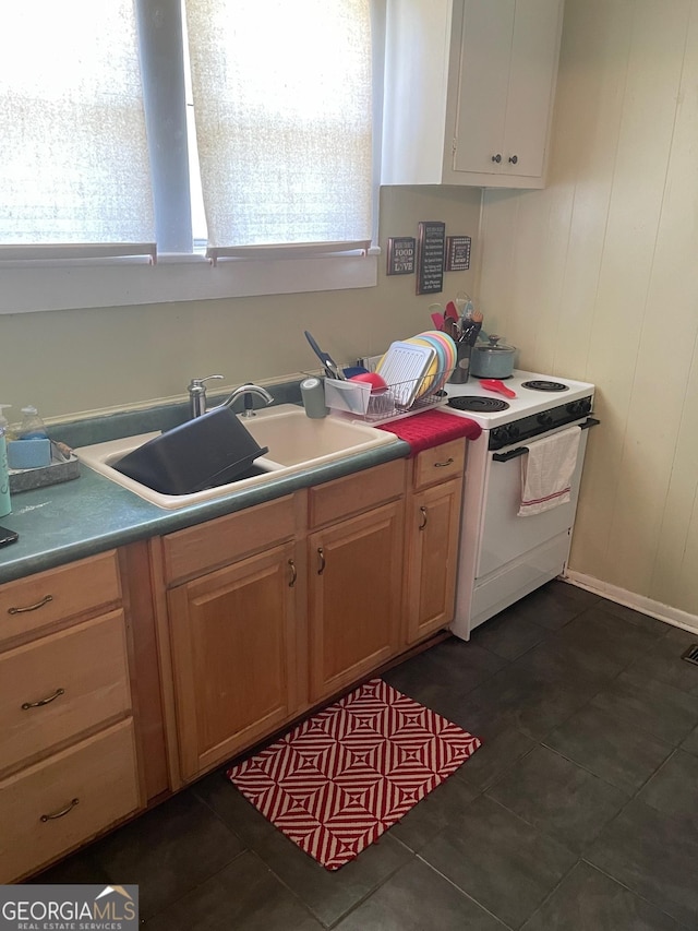 kitchen featuring dark tile patterned flooring, sink, and white electric stove