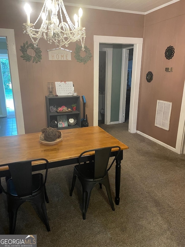 carpeted dining room featuring ornamental molding and a notable chandelier