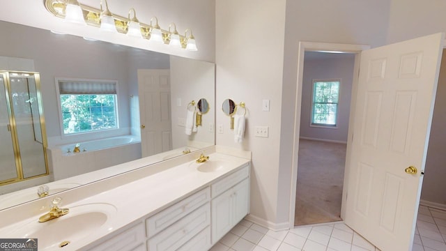 bathroom featuring tile patterned flooring, independent shower and bath, and vanity