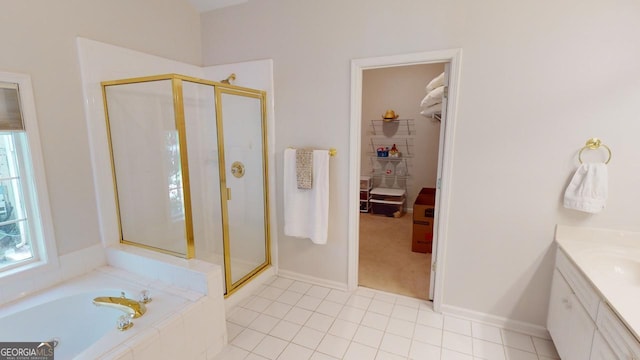 bathroom with tile patterned floors, independent shower and bath, and vanity