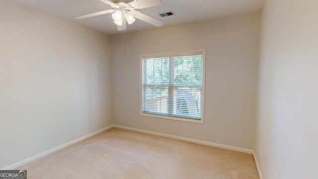 carpeted empty room featuring ceiling fan