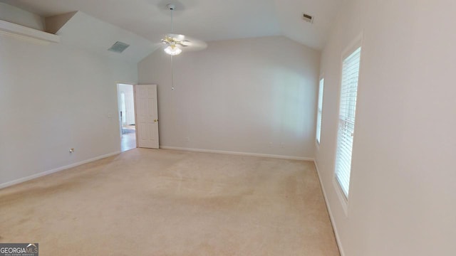 1461 Hada Ln, Lawrenceville, GA 30043 - empty room with a ceiling fan, vaulted ceiling, healthy amount of natural light, and light carpet