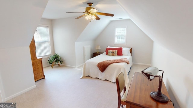 bedroom featuring multiple windows, lofted ceiling, light carpet, and ceiling fan