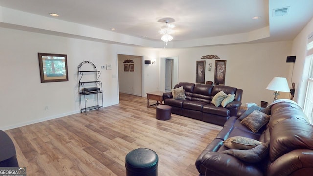 living room with light wood-type flooring and ceiling fan