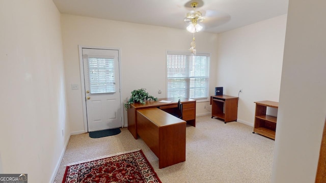 office space featuring light carpet and ceiling fan