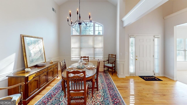 1461 Hada Ln, Lawrenceville, GA 30043 - dining area featuring a chandelier, light wood-style floors, and high vaulted ceiling