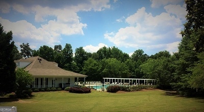 1461 Hada Ln, Lawrenceville, GA 30043 - view of grassy yard featuring an outdoor pool and a view of trees