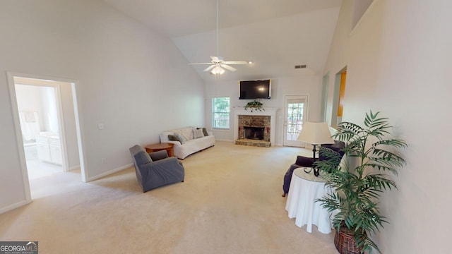 carpeted living room with high vaulted ceiling, ceiling fan, and a stone fireplace