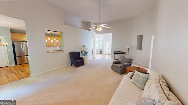 living room featuring ceiling fan, light colored carpet, and high vaulted ceiling