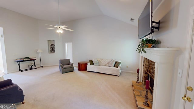 carpeted living room featuring ceiling fan, a premium fireplace, and high vaulted ceiling