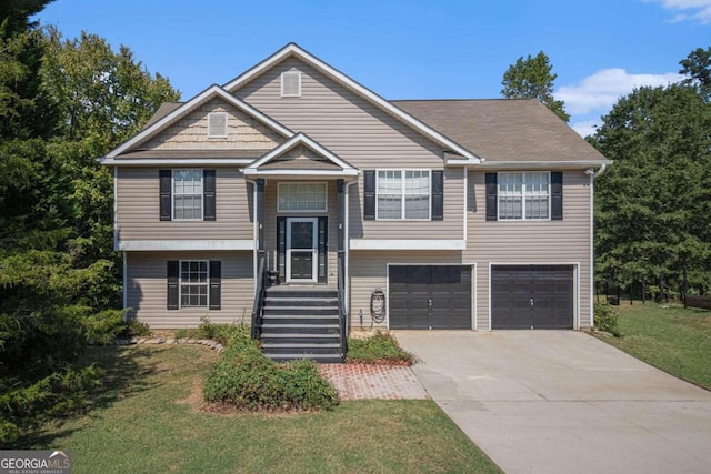 bi-level home featuring a garage and a front lawn