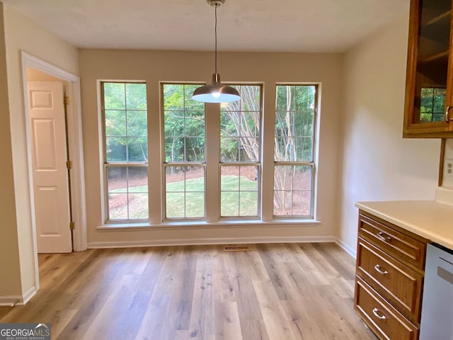 unfurnished dining area with light wood-type flooring