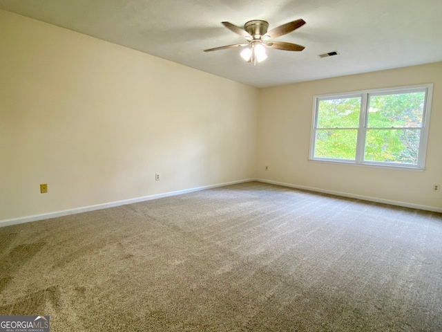 unfurnished room with ceiling fan and carpet flooring