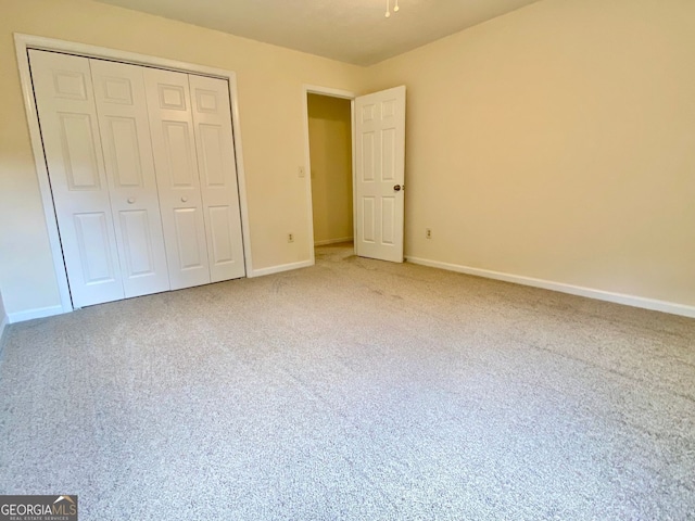 unfurnished bedroom featuring a closet and carpet