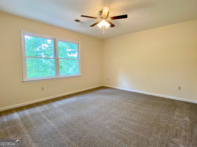 carpeted empty room featuring ceiling fan