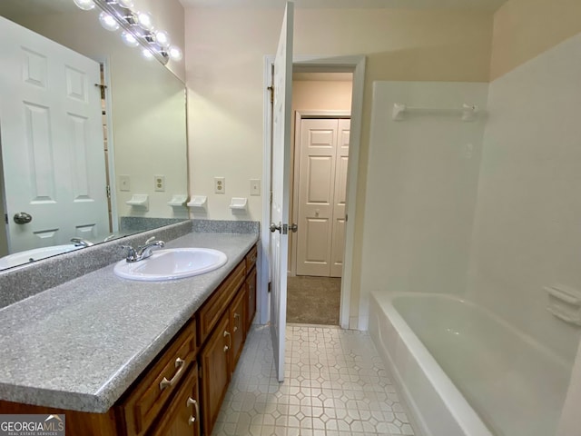 bathroom with vanity and a tub